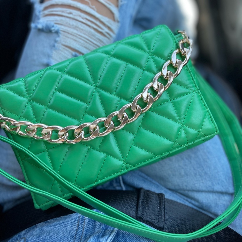 Small green fold over purse with gold chain and crossbody strap